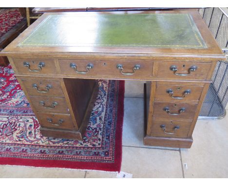 An early 1900's oak nine drawer twin pedestal desk - Height 75cm x 108cm x 58cm 