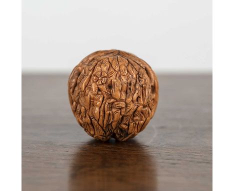 Natural walnut Chinese, circa 1900, carved with sixteen Lohans, guardians of the faith, 4cm approxProvenance; an Oxfordshire 
