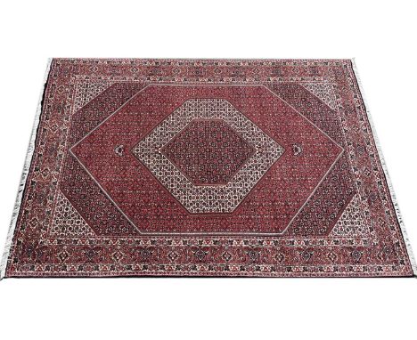 Persian Bidjar carpet20th Century, with stylised repeating medallion pattern decorated with floral motifs, 303cm x 204cmSigns