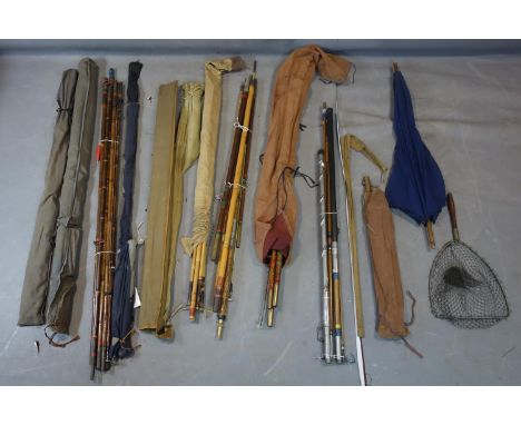 A collection of 10 vintage fishing rods to include 2 split cane and 8 bamboo, together with an umbrella and a net 