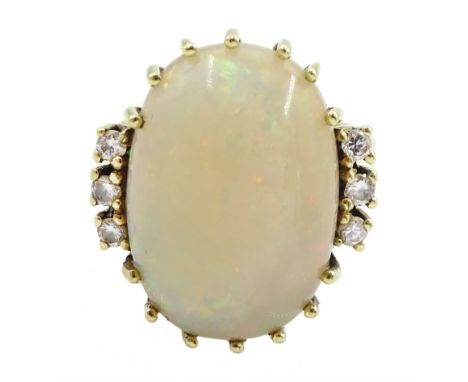 14ct gold oval opal ring, each side set with three diamonds, stamped 585