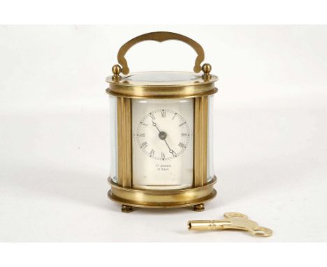 A c.1950's brass and five glass, oval section carriage clock. with white Roman chapter dial, 17 jewel, 8-day movement and sha