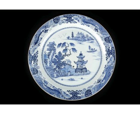 A LARGE CHINESE BLUE AND WHITE CHARGER.
Qing Dynasty, c. 1800.
The central roundel painted with a landscape scene based on an