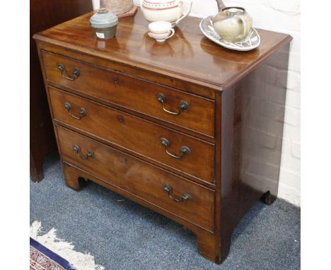 A Victorian mahogany chest of three drawers, with line inlaid decoration on bracket feet.