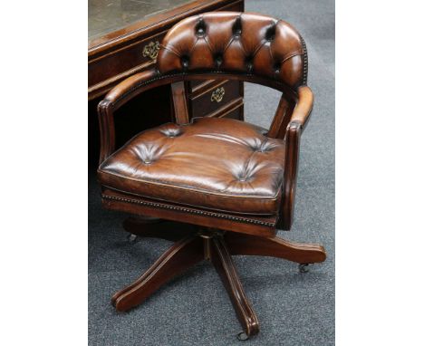 Captain's chair, mahogany frame, button back tan upholstery.