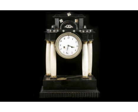 A late Victorian / Edwardian portico mantle clock, having ebonised pediment with applied mother of pearl decorations, support