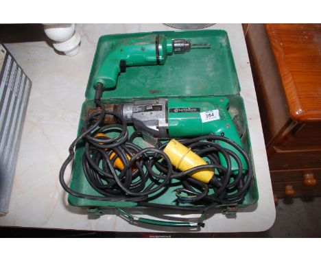 Two cased Hitachi 110 volt electric drills.