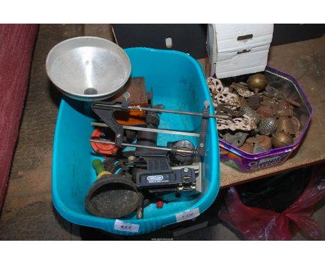 A tray of door furniture, grease gun etc. also a chainsaw sharpener.