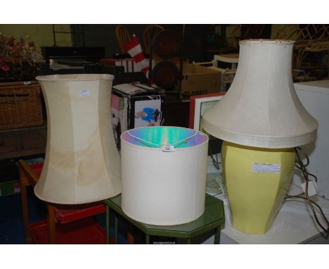 Three standard lamp lampshades and a large yellow lamp.