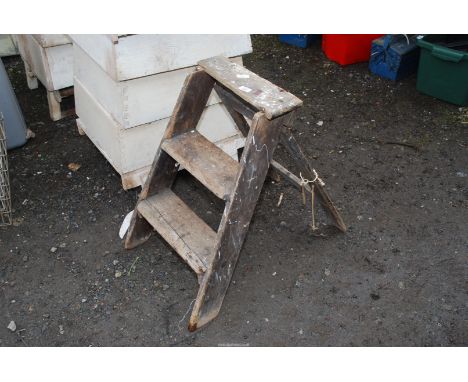 A small wooden three rung step ladder.