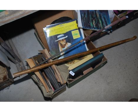 A thumb walking stick, wooden golf clubs, old records, 78's etc.