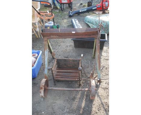 A dog grate, cast iron wheels with axle from a hay rack, saw horse and pond weeder.