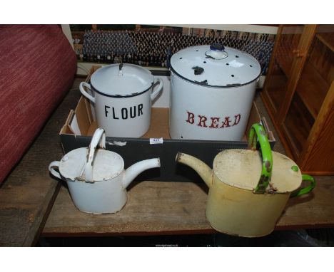 Enamel watering cans, a bread bin and a flour bin.