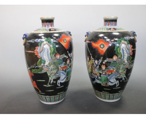 A pair of famille noir vases, six character mark of Kangxi  