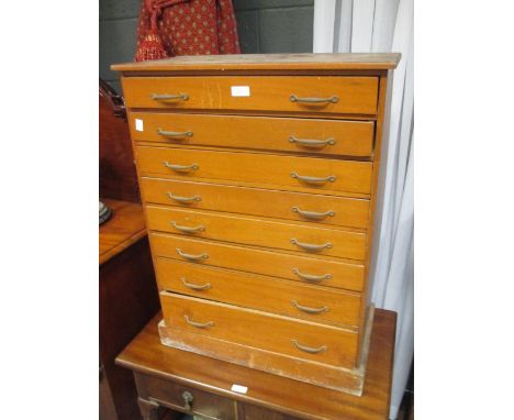 A George III mahogany stool with upholstered seat (repaired) and a set of eight drawers  