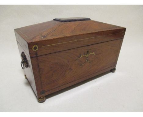 A Regency rosewood and brass inlaid sarcophagus shape tea caddy, on ball feet, lacking mixing bowl  