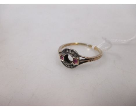 A ruby and diamond ring, the open band of rose cut diamonds set to either side with a small ruby to tri-furcated shoulders a 