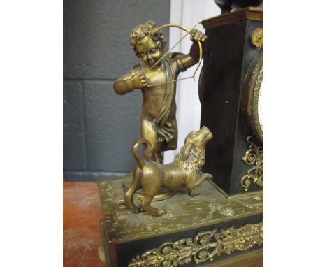 A 19th century French Empire style black slate and gilt metal mounted mantle clock, the enamel dial showing Roman numerals, a