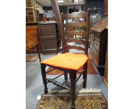 A set of seven 20th century oak ladder back dining chairs with rush seats  