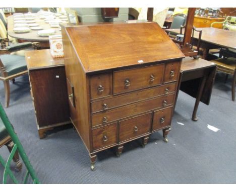 A Regency mahogany Gentleman's fitted washstand, with hinged sloping top, fitted interior with basin, deep amd long drawers, 