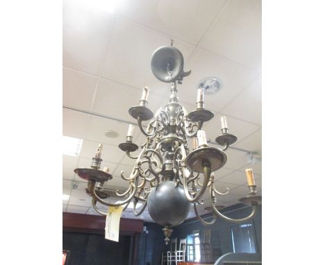 A large heavy brass Dutch style ceiling light with typically shaped branches  