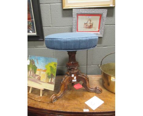 A Victorian carved walnut piano stool  