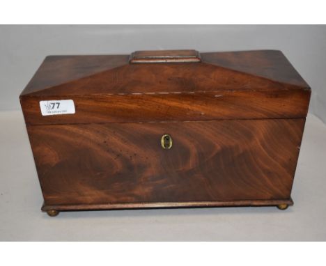 A Victorian tea caddy of casket form with fitted mahogany boxed interior, on brass ball feet with brass handles.