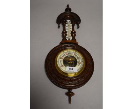 An early 20th century carved mahogany barometer, with milk glass thermometer scale