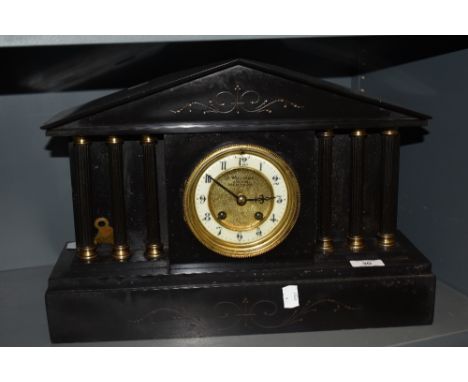 A Victorian Gothic slate mantel clock having Roman column supports with enamel dial reading J Williams Arcade Merthyr