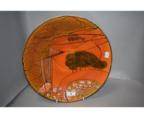 A large mid century Poole pottery Delphis charger plate decorated with a landscape scene 34cm wide.