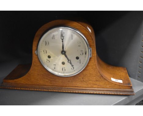 An Edwardian mantel clock having oak case in a Napoleon design AF