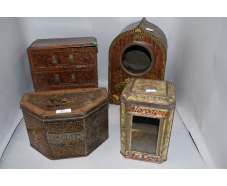 A group of four novelty biscuit tins, formed as a mantel clock, chest of drawers, tin with windowed aperture and one as a coa