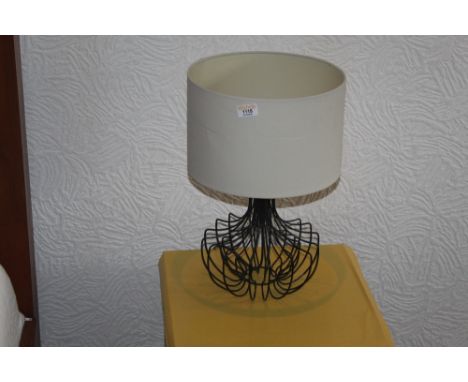 A decorative modern wire based table lamp, with cream coloured shade.  CONDITION REPORT: Appears to be in good used condition
