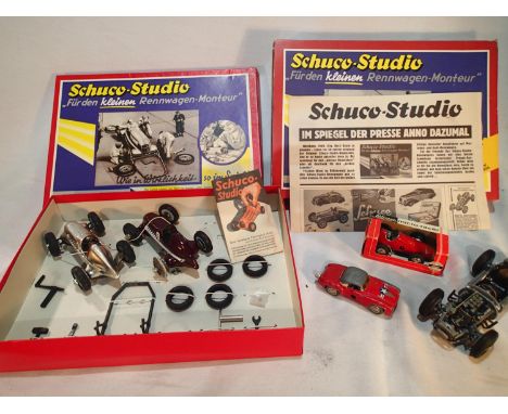 Two Schuco Studio cars, with spanners, lift, spare tyres etc, plus two Schuco micro racers (one boxed) and part built racing 