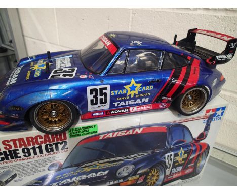 Tamiya 1/10 scale electric Porsche 911 GT2, built and finished, plus radio control spares including batteries, transmitter et