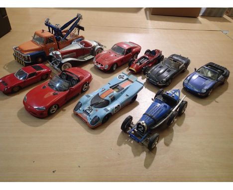 Ten mostly 1/18 scale diecast cars, trucks, racing cars, all ex display, some missing parts, unboxed. UK P&amp;P Group 3 (£30