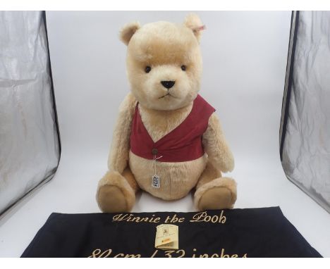Steiff Bears, Winnie the Pooh, with tag unattached with tearing, pin in ear with white label/red text, jacket in tact and wit