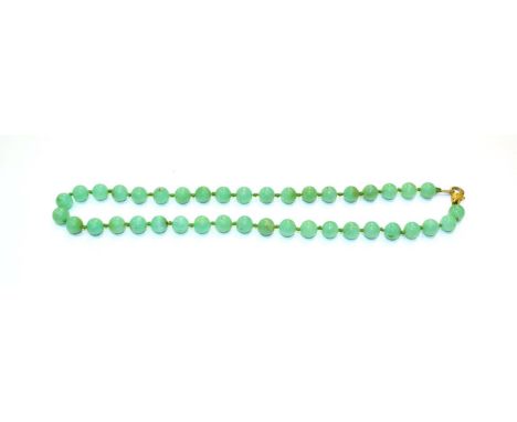 A chalcedony bead necklace, length 53.5cm and a jade pendant, measures 4.1cm by 2.9cm 