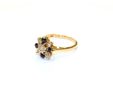 An 18 carat gold sapphire and diamond cluster ring, finger size L1/2.  Gross weight 4.0 grams. 