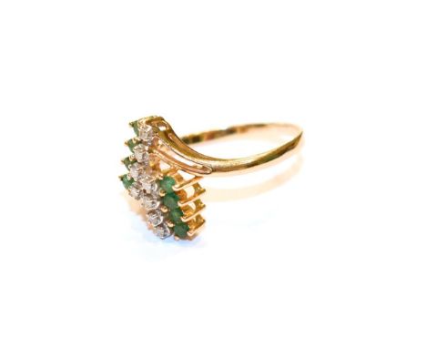 An abstract emerald and diamond ring, stamped '585', finger size S.  Gross weight 3.5 grams. 