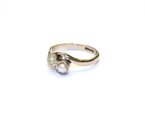 A diamond and cultured pearl crossover ring, stamped '18CT' and 'PT', finger size I .  Gross weight 2.9 grams. 