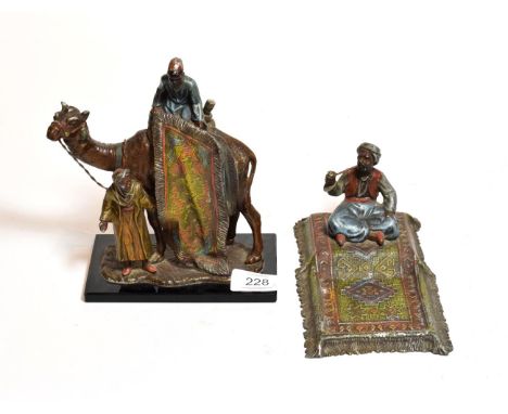 After Bergmann: An Orientalist style figural table lighter of a camel and rider together with a similar ashtray (2)