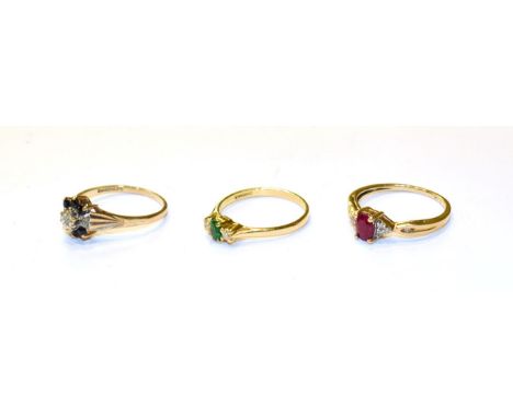 A ruby and diamond ring, stamped '10K', finger size N, an 18 carat gold emerald and diamond three stone ring, finger size N1/