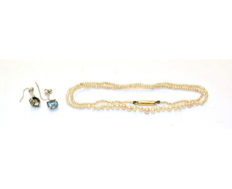 A seed pearl necklace, length 40cm and a pair of blue zircon drop earrings, length 2.1cm 