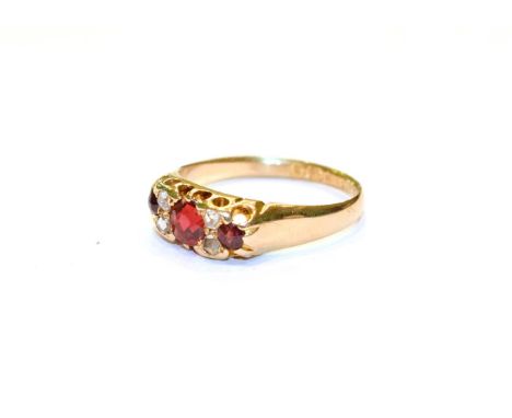 An 18 carat gold garnet topped doublet and diamond seven stone ring, finger size O.  Gross weight 3.0 grams. 