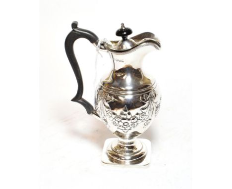 A Victorian silver hot water jug, Chester, 1899, baluster and on square base, the sides chased with ribbon tied foliage swags