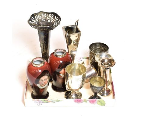 A collection of assorted silver vases and cups, including a pair of silver-mounted ceramic vases, each painted with the bust 