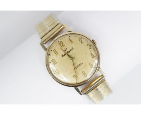 A Gentleman's Smiths Imperial 9ct gold wristwatch, circular dial with gold toned Roman numerals, set to a plain polished 9ct 