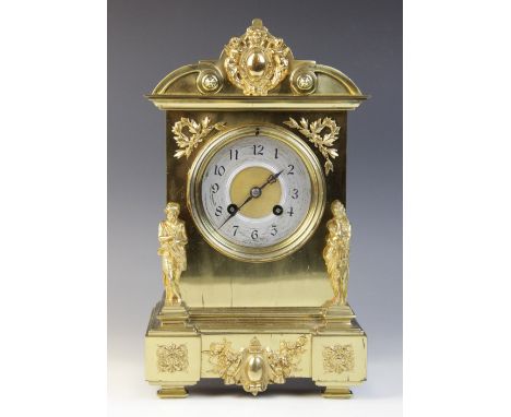 A late 19th century French brass cased mantel clock by Japy Freres, the architectural case applied with wreath spandrels and 