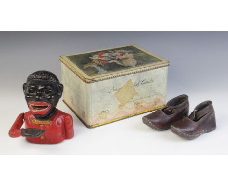A pair of children's leather shoes, late 19th/early 20th century, with ankle straps, 13.5cm long, a vintage 'Jolly' cast iron